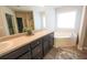Bathroom featuring a separate soaking tub, tile floor, double vanity, and lots of natural light at 175 Diamond Ridge Ave, Canton, GA 30114