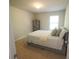 This bedroom features neutral paint, a window for natural light, and soft carpet flooring at 175 Diamond Ridge Ave, Canton, GA 30114