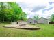 Backyard with firepit, above ground pool, and patio with plenty of green space at 238 Knob Hill Dr, Locust Grove, GA 30248