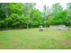 Large grassy backyard with fire pit, playset, shed, and above ground pool at 238 Knob Hill Dr, Locust Grove, GA 30248