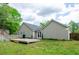 Back view of the home showing the yard, deck and patio with a firepit at 238 Knob Hill Dr, Locust Grove, GA 30248