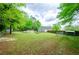 Vast lawn in a fenced backyard, showcasing the shed, pool, and lush greenery at 238 Knob Hill Dr, Locust Grove, GA 30248