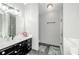 Bathroom featuring vanity, modern mirror and lighting, with a glass door walk-in shower at 238 Knob Hill Dr, Locust Grove, GA 30248