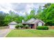 Well-maintained home with brick facade, attached garage, and verdant front yard at 238 Knob Hill Dr, Locust Grove, GA 30248