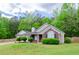 Charming one-story home with brick accents, a well-manicured lawn, and mature landscaping at 238 Knob Hill Dr, Locust Grove, GA 30248