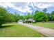 Long driveway leading to a brick home with a detached garage and well-kept lawn at 238 Knob Hill Dr, Locust Grove, GA 30248