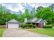 Charming brick home with well-manicured lawn, attached garage, and inviting curb appeal at 238 Knob Hill Dr, Locust Grove, GA 30248