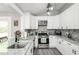 Modern kitchen featuring stainless steel appliances, granite countertops, and ample cabinet space at 238 Knob Hill Dr, Locust Grove, GA 30248