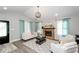 Cozy living room with stone fireplace, modern lighting, and comfortable seating arrangement at 238 Knob Hill Dr, Locust Grove, GA 30248