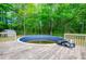 Backyard featuring in-ground pool surrounded by a wood deck in a wooded yard at 238 Knob Hill Dr, Locust Grove, GA 30248