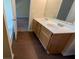 Bathroom with a double sink vanity, tub, and tile floors at 2432 Pendergrass Ln, Ellenwood, GA 30294