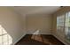 Bright room with wood floor and window with blinds letting in the light at 2432 Pendergrass Ln, Ellenwood, GA 30294