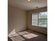 Bright bedroom with a large window and plush carpeting at 2432 Pendergrass Ln, Ellenwood, GA 30294