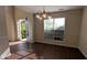 Bright dining area with dark hardwood floors, neutral walls, and natural light streaming through windows at 2432 Pendergrass Ln, Ellenwood, GA 30294