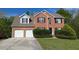 Charming two-story brick home with a well-maintained lawn and a two-car garage at 2432 Pendergrass Ln, Ellenwood, GA 30294