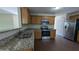 Updated kitchen featuring granite countertops, stainless steel appliances, and wood cabinets at 2432 Pendergrass Ln, Ellenwood, GA 30294