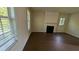 Comfortable living room featuring a fireplace, neutral paint, and hardwood floors at 2432 Pendergrass Ln, Ellenwood, GA 30294