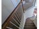 A carpeted staircase with wooden handrails at 2432 Pendergrass Ln, Ellenwood, GA 30294
