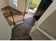 View of a carpeted staircase leading to a bright entry at 2432 Pendergrass Ln, Ellenwood, GA 30294