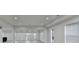 A spacious finished basement with recessed lighting, windows, and light wood-look flooring at 4155 Winterberry Rd, Cumming, GA 30040