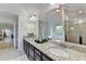 Bright bathroom featuring a granite countertop, dual sinks, and a large mirror at 4155 Winterberry Rd, Cumming, GA 30040