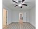 A bedroom featuring wood-look flooring, a ceiling fan, and a view of another room at 4155 Winterberry Rd, Cumming, GA 30040