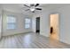 A bedroom featuring wood-look flooring, a ceiling fan, and access to the bathroom at 4155 Winterberry Rd, Cumming, GA 30040