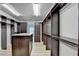 Spacious walk-in closet with custom shelving and a granite-topped island at 4155 Winterberry Rd, Cumming, GA 30040