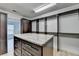 Walk-in closet boasts custom shelving, a granite-topped island, and ample storage at 4155 Winterberry Rd, Cumming, GA 30040