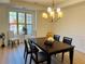 Cozy dining room with wood floors, chandelier, and large window at 4155 Winterberry Rd, Cumming, GA 30040