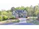 Brick home with well-manicured lawn and landscaping on a verdant lot at 4155 Winterberry Rd, Cumming, GA 30040
