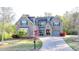 Charming brick home with a well-manicured lawn and a curved driveway at 4155 Winterberry Rd, Cumming, GA 30040