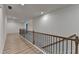 Bright hallway featuring hardwood floors, decorative railings, and recessed lighting, creating an inviting transition space at 4155 Winterberry Rd, Cumming, GA 30040