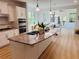 Bright kitchen featuring stainless steel appliances, granite countertops, and a view into the dining area at 4155 Winterberry Rd, Cumming, GA 30040
