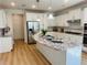Bright open kitchen with white cabinets, a large island, and stainless steel refrigerator at 4155 Winterberry Rd, Cumming, GA 30040