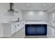 Modern kitchen boasts white cabinetry, stainless steel appliances, and a contrasting blue island at 4155 Winterberry Rd, Cumming, GA 30040