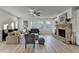 Bright living room boasts stone fireplace, hardwood floors, and large windows at 4155 Winterberry Rd, Cumming, GA 30040