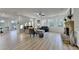 Open-concept living room, features a stone fireplace, and access to the dining room at 4155 Winterberry Rd, Cumming, GA 30040