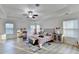 Bright main bedroom offering ample natural light, tray ceilings, ceiling fan, and neutral color scheme at 4155 Winterberry Rd, Cumming, GA 30040
