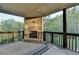 Charming screened porch with a cozy fireplace, providing a comfortable outdoor living space at 4155 Winterberry Rd, Cumming, GA 30040