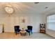 Inviting sitting room with hardwood floors, decoratove chandelier, and modern furnishings at 4155 Winterberry Rd, Cumming, GA 30040