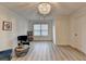 Bright sitting room with hardwood floors, a decorative chandelier, and large window at 4155 Winterberry Rd, Cumming, GA 30040