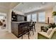 Stylish bar area with seating, custom cabinets, and accent lighting, perfect for relaxing and entertaining at 105 Aspen Hall Dr, Canton, GA 30115