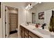 Well-lit bathroom featuring dual sinks, modern fixtures, and a neutral color scheme at 105 Aspen Hall Dr, Canton, GA 30115