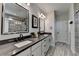 Modern bathroom with double sinks, gray countertops, a walk-in shower, and elegant fixtures at 105 Aspen Hall Dr, Canton, GA 30115