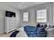Comfortable bedroom featuring a chest of drawers with TV and bright windows with shutter blinds at 105 Aspen Hall Dr, Canton, GA 30115