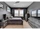 Modern bedroom featuring a dark color palette, a plush bed, and natural light at 105 Aspen Hall Dr, Canton, GA 30115