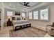 Bedroom with a tray ceiling, a ceiling fan, neutral walls, large windows and an area rug at 105 Aspen Hall Dr, Canton, GA 30115