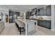 Modern kitchen with gray cabinets, marble countertops, an island with bar seating, and stainless steel appliances at 105 Aspen Hall Dr, Canton, GA 30115