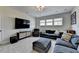 Comfortable living room featuring a large TV, sectional sofa, plush seating, and neutral colors at 105 Aspen Hall Dr, Canton, GA 30115